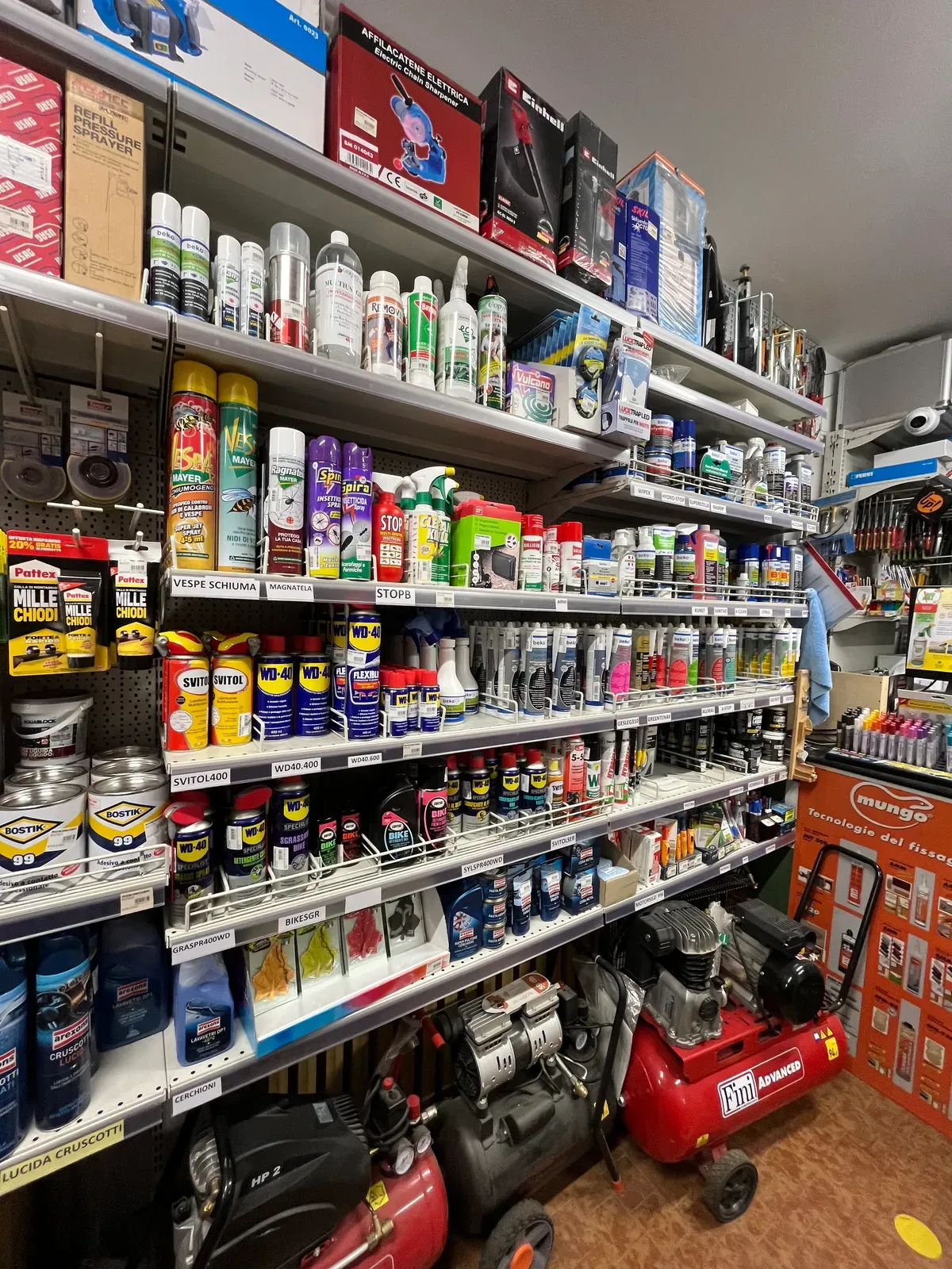 Corsia con vernici, bombolette spray e prodotti per la casa